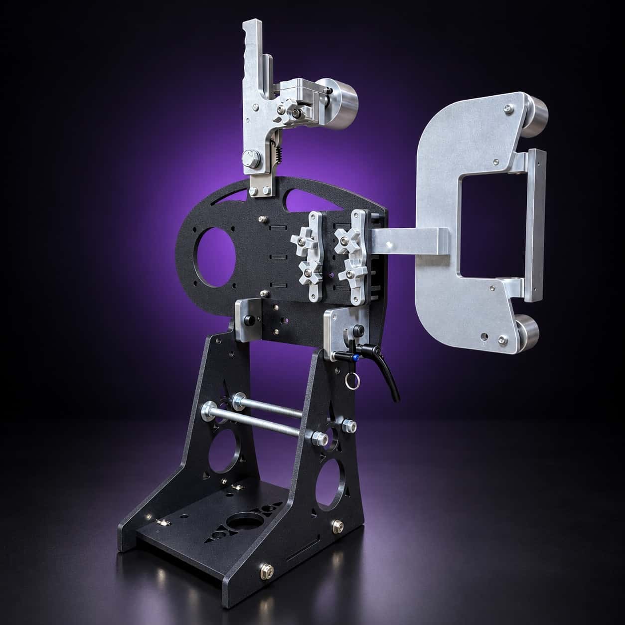 Nebula 2x72 grinder, front-left view: tension arm, flat platen with two wheels and black base, on black with a purple glow